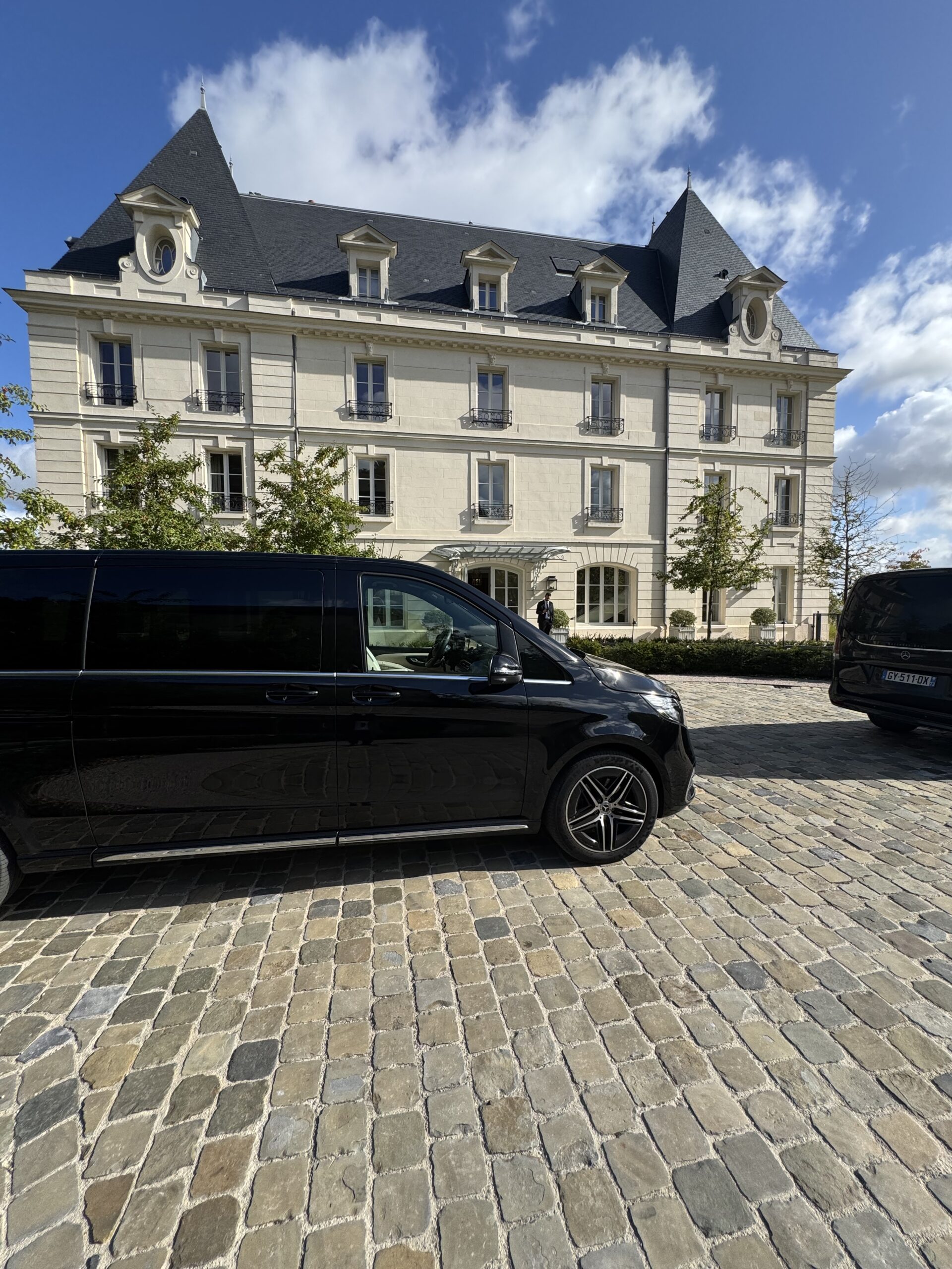 Mercedes V-Class private chauffeur parked outside a luxury hotel in Champagne